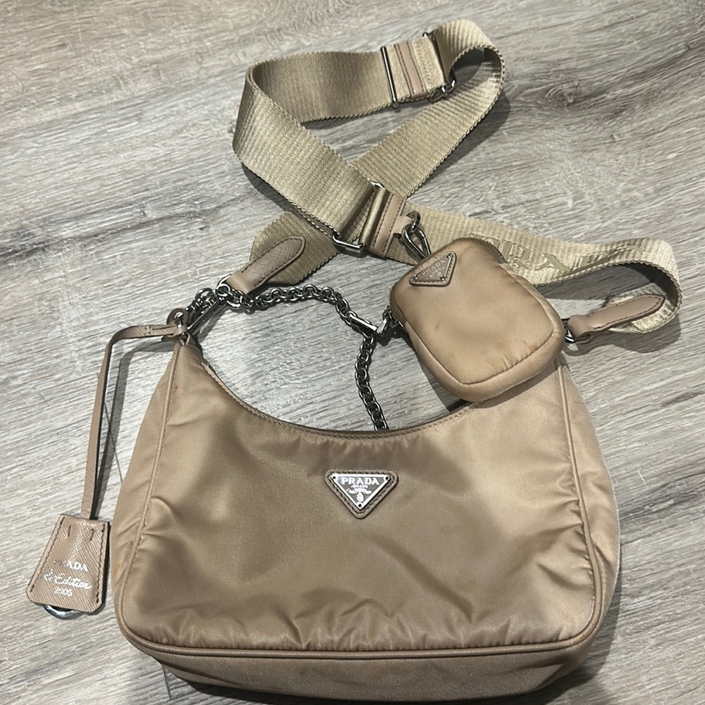 Nude nylon re-edition Prada bag with removable strap.